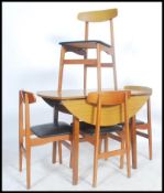 A retro mid century dining room suite comprising a faux wood formica drop leaf dining table raised