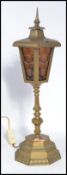A vintage early 20th century brass lantern raised on a stepped octagonal base with knopped stem. The