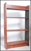 An early 20th century pine waterfall open bookcase fitted with a series of graduating fixed shelves.