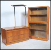 A vintage 20th century teak wood lawyers stacking bookcase cabinet of sectional form with glass