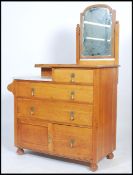 A 1930's Waring & Gillows solid oak and marble dressing table / chest of drawers having an