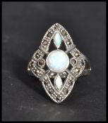 A sterling silver art deco style ring having opals and marcasites. Size Q weighs 7 grams.
