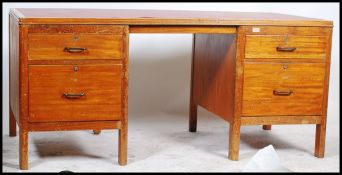 An early to mid 20th century Edwardian War Department oak twin pedestal desk, rectangular top with