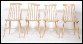 A set of four 20th century beech wood  hoop back dining chairs in the manner of Ercol. Measures