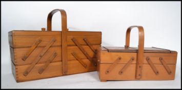 Two vintage retro 20th century metamorphic sewing boxes having fold over lid panels with hoop