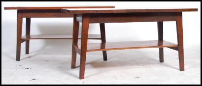 A pair of retro 20th century plank topped coffee tables being two tiered made from mahogany and