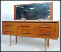 A 20th century vintage Danish style teak wood dressing table in the manner of Mogens Kolo. Raised on