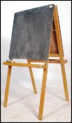 A vintage 20th century children's easel blackboard being double sided complete with twin tray's that