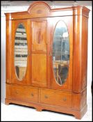 An Edwardian mahogany large double wardrobe. Raised on plinth base with twin drawers having large