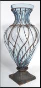 A large 20th century tall studio glass and worked metal vase the cast metal base rising and
