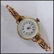 An unusual vintage 20th century yellow metal cocktail watch having a mother of pearl back and