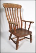 A 19th century Victorian beech and elm wood windsor chair / armchair. Raised on turned legs united