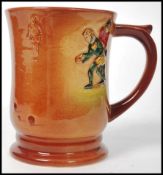 A Royal Doulton tankard having polychrome decoration in relief depicting Francis Drake playing bowls