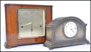 Two early 20th century clocks. One being a wooden cased clock with silvered dial with gilt faceted