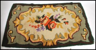 An early 20th century Tibetan floral rug.  The green ground with large central medallion of