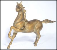 A 20th century cold painted bronze cast figurine of a spirited  Arabian horse, the horse appearing