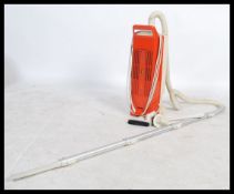 A retro 20th century 1970's orange Hoover / Vacuum