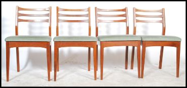 A set of 4 20th century, circa 1970's teak wood dining chairs of Danish influence. Raised on squared