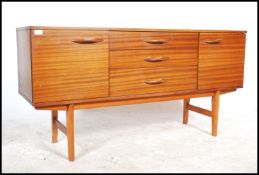 A vintage / retro 20th century teak wood sideboard consisting of a bank of three drawers flanked