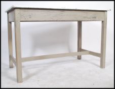 A vintge mid 20th century industrial / scientific work bench table raised on square legs and