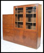 A 1930's Art Deco oak cabinet bureau bookcase of unusual configuration, glazed doors over panel