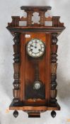 A Vienna-styled wall clock, walnut case with opening glazed door flanked by geometric decoration,