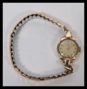 A ladies 9ct gold Summit ladies cocktail fitted to an expanding gold plated bracelet.