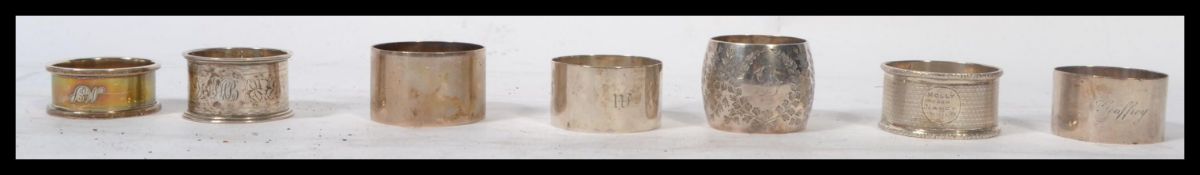 A group of seven silver hallmarked napkin rings to include a pair of A J Pepper & Co 1918 , Mappin
