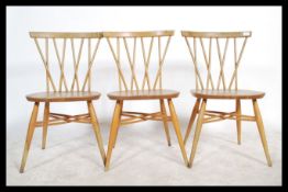 A set of three fantastic vintage mid 20th Century Ercol Windsor beech and elm cross back candlestick
