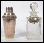 A vintage 20th century Art Deco silver plated cocktail shaker along with a cut glass decanter with a