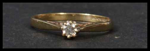 A 9ct gold hallmarked single stone diamond solitaire ring. The central stone approx 8-10pnts being