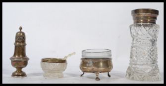 A group of silver items to include a hallmarked silver topped and cut glass tall sugar shaker sifter
