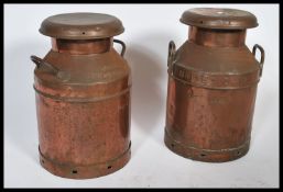 A near matching pair of mid 20th century copper milk churns, twin handled and with original lid each