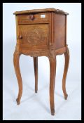 A 20th century French carved fruit wood marble topped bedside cabinet / pot cupboard raised on