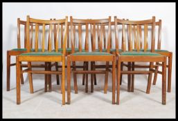 A set of eight 20th century circa 1940's oak rail back dining chairs, drop in seats raised on square