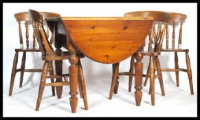 A 20th century country pine dining room suite of four pine dining chairs and a pine drop leaf dining