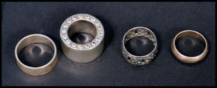 A collection of silver band rings including pierce
