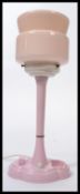 A vintage 20th century Art Deco bakelite bedside table lamp in a stunning pink colour way, raise