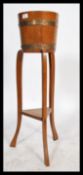 A 19th century coopered oak and brass bound barrel planter - plant stand torchere by Lister of