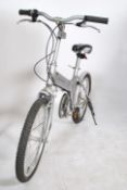 A contemporary 20th century Giant folding bicycyle in silver colourway with stand, saddle and