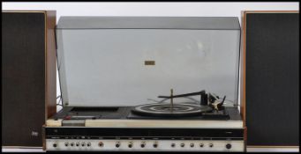 A 20th century Ferguson retro Studio 6 BSR record player in a teak finish with acryllic hood being