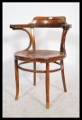 A vintage early 20th century bentwood elbow armchair in the manner of Thonet. Measures: 82cm high