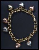 A 14 carat gold Italian designer 585 stamped bracelet chain having heart drop charms. Weighs 16