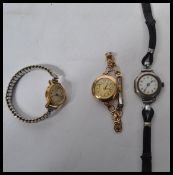 A group of three vintage watches - a sterling silver example with white enamel face and faceted