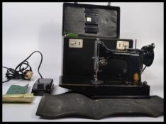 A 20th century vintage Singer Featherlite 221K sewing machine complete in the original carry case