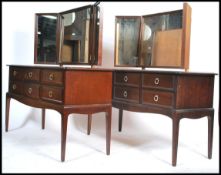 A pair of 20th century mahogany Stag Minstrel matching dressing tables each having an arrangement of