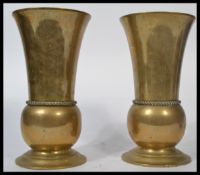 A large pair of heavy late 19th / early 20th century bronze vases raised on stepped circular bases