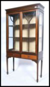 An Edwardian mahogany inlaid glazed display cabinet fitted with moulded cornice over two astragal