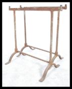 A pair of early 20th century workmens cast metal trestle ends - coffine stands ideal for