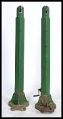 A superb pair of vintage wooden early 20th century tennis net posts with cast iron bases and